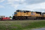 UP 4971 passes a MoPac caboose on display at the Rosenberg Railroad Museum